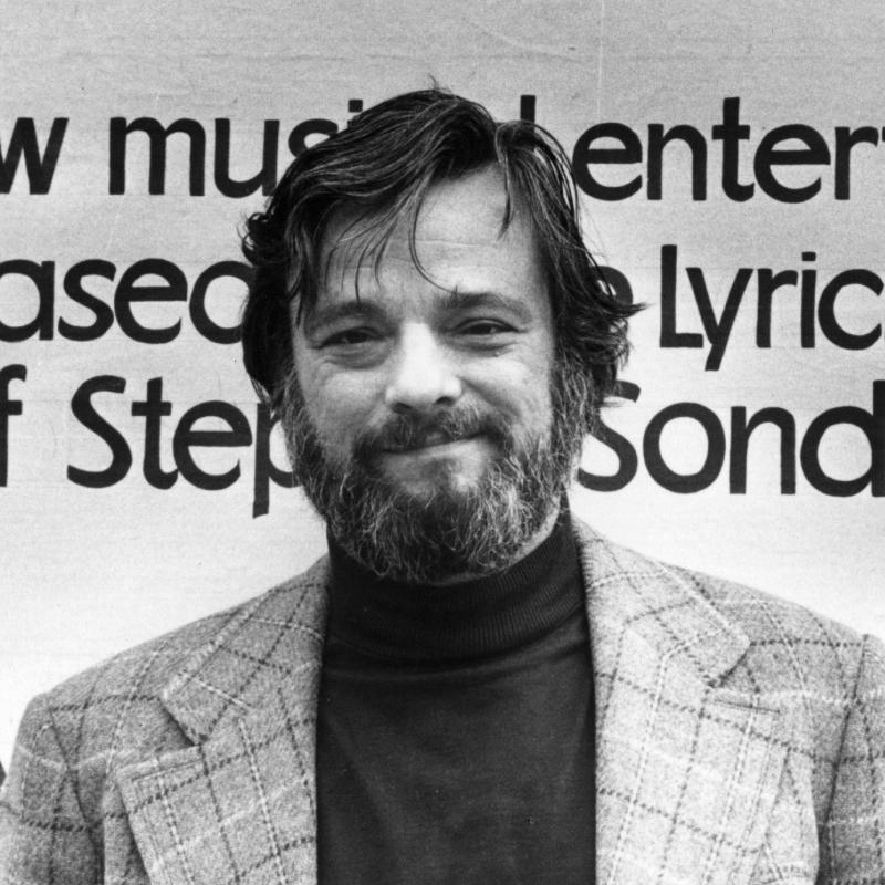 Composer and lyricist Stephen Sondheim poses for a portrait in front of a sign advertising one of his musicals